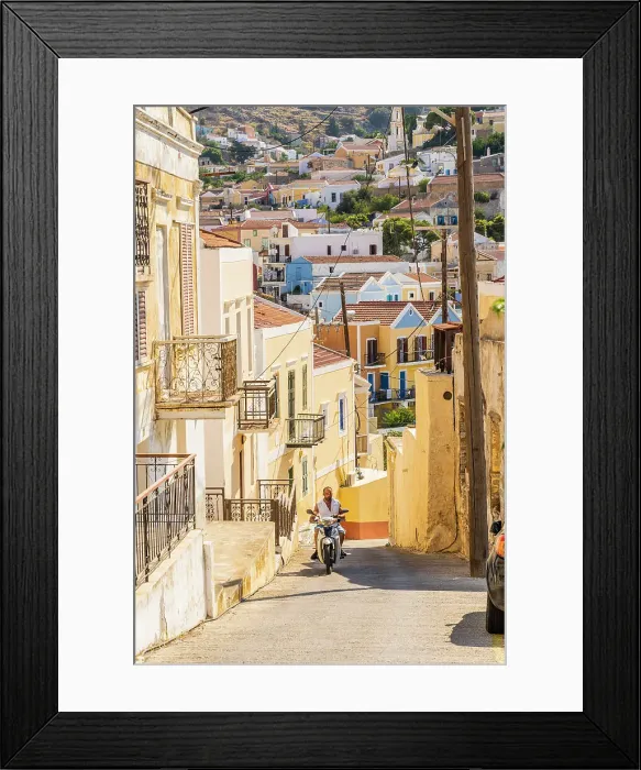 Framed Print : A man riding a scooter in Symi, Dodecanese Islands, Greece Framed Print : A man riding a scooter in Symi, Dodecanese Islands, Greece
