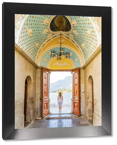 A woman in a hat at Panormitis Monastery, Symi, Dodecanese Islands, Greece. (MR)Symi, Dodecanese Islands, Greece. (MR)