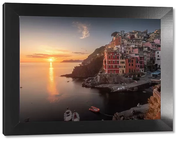 A clear sky over the town of Riomaggiore, part of the Cinque Terre in Italy, during a spring sunset. Cinque Terre, Italy