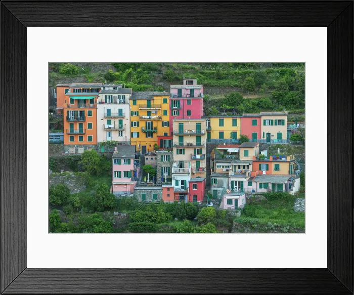 Framed Print : A group of colorful houses standing out on the hills above Manarola, one of the Cinque Terre, at dusk. Cinque Terre, Italy