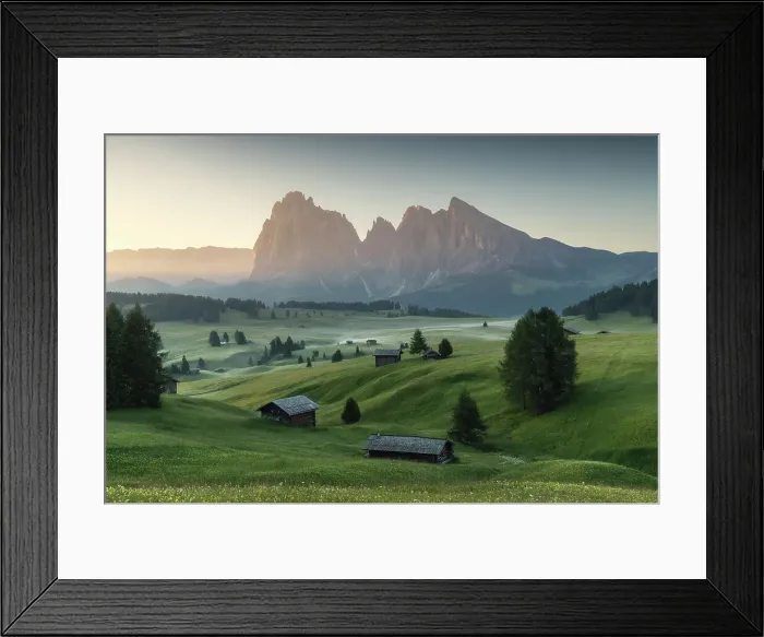 Framed Print : Meadows of the Alpe di Siusi (Seiser Alm), with the Sassolungo and Sassopiatto wooden cabins. Dolomites, Italy