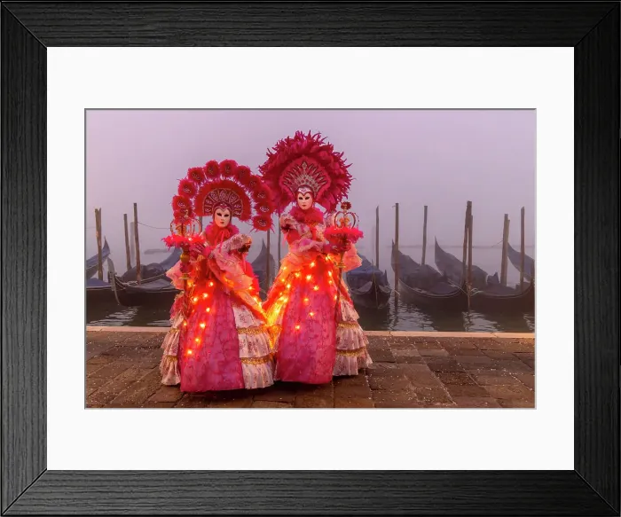 Framed Print : Italy, Veneto, Venice, two models in illuminated costumes pose in front of gondolas on a foggy morning during the Venice Carnival Framed Print : Italy, Veneto, Venice, two models in illuminated costumes pose in front of gondolas on a foggy morning during the Venice Carnival