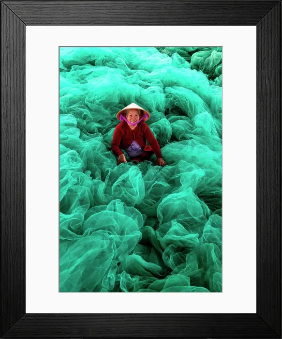 Framed Print : Vietnam, Cam Rahn, a woman mends green fishing nets