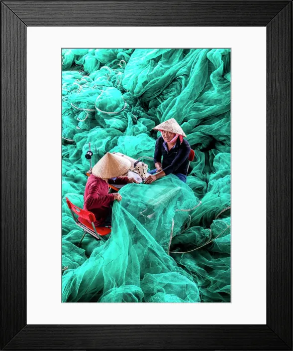 Framed Print : Vietnam, Cam Ranh, two men repair green fishing nets using a sewing machine Framed Print : Vietnam, Cam Ranh, two men repair green fishing nets using a sewing machine