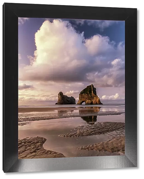Archway Islands Reflecting in Wharariki Beach, South Island, New Zealand