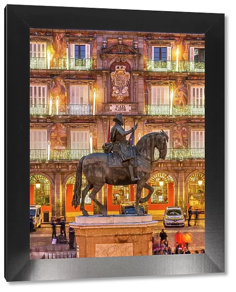 Equestrian statue of Philip III King of Spain with christmas lights behind, Plaza Mayor, Madrid, Spain