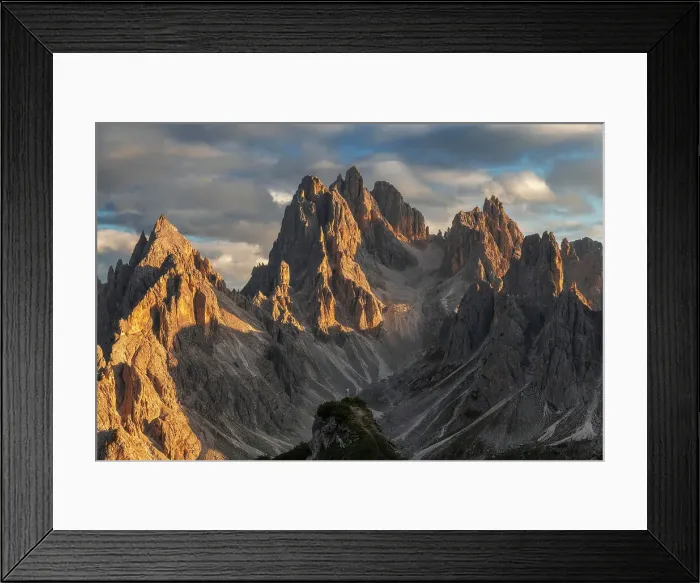 Framed Print : A lone person standing against the rugged Cadini di Misurina in the background at sunset. Dolomites, Italy