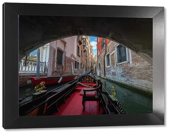 A gondola ride in Venice, navigating through the small canals of the city centre. Venice, Italy
