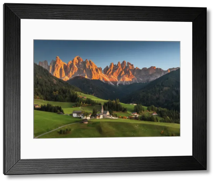 Framed Print : The classic view of the Santa Magdalena church during an early autumn sunset, with the Odle rising tall in the background. Dolomites, Italy Framed Print : The classic view of the Santa Magdalena church during an early autumn sunset, with the Odle rising tall in the background. Dolomites, Italy