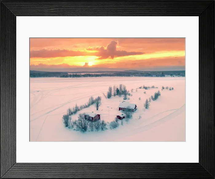 Framed Print : Europe, Finland, Rovaniemi, aerial view of a frozen lake near Rovaniemi with traditional red buildings with the sun rising on a winter morning Framed Print : Europe, Finland, Rovaniemi, aerial view of a frozen lake near Rovaniemi with traditional red buildings with the sun rising on a winter morning