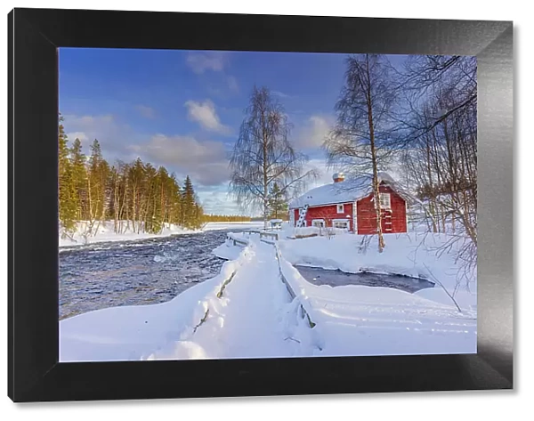 Europe, Finland, red house by the river near Ruka