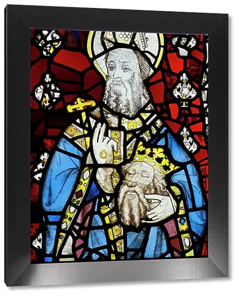UK, England, Yorkshire, York, interior of York Minster, medieval 15th Century stained glass showing Saint Cuthbert holding the head of St. Oswald, a Christian Anglo-Saxon king of Northumbria, who died in battle against the pagan king