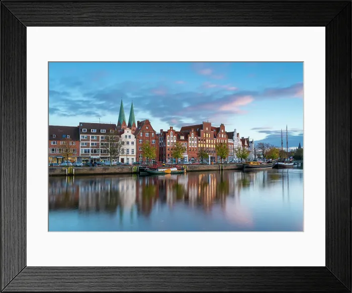 Framed Print : Houses on riverfront of Trave river with towers of St. Marienkirche church in background at sunset, Lubeck, UNESCO, Schleswig-Holstein, Germany Framed Print : Houses on riverfront of Trave river with towers of St. Marienkirche church in background at sunset, Lubeck, UNESCO, Schleswig-Holstein, Germany