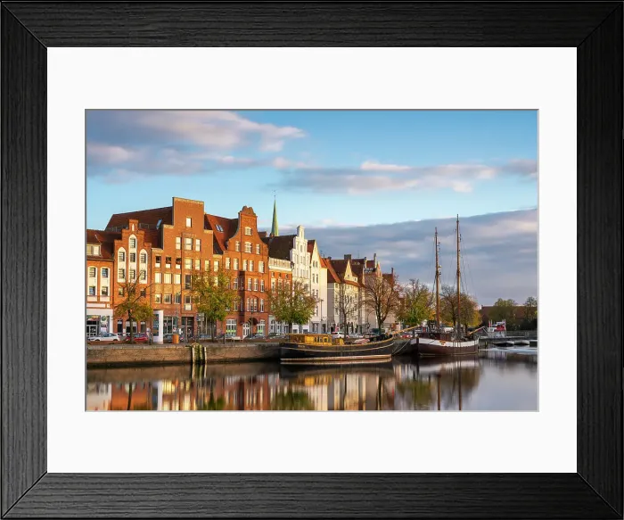 Framed Print : Boats anchored on Trave river and houses with traditional gables in background at sunset, Lubeck, UNESCO, Schleswig-Holstein, Germany Framed Print : Boats anchored on Trave river and houses with traditional gables in background at sunset, Lubeck, UNESCO, Schleswig-Holstein, Germany