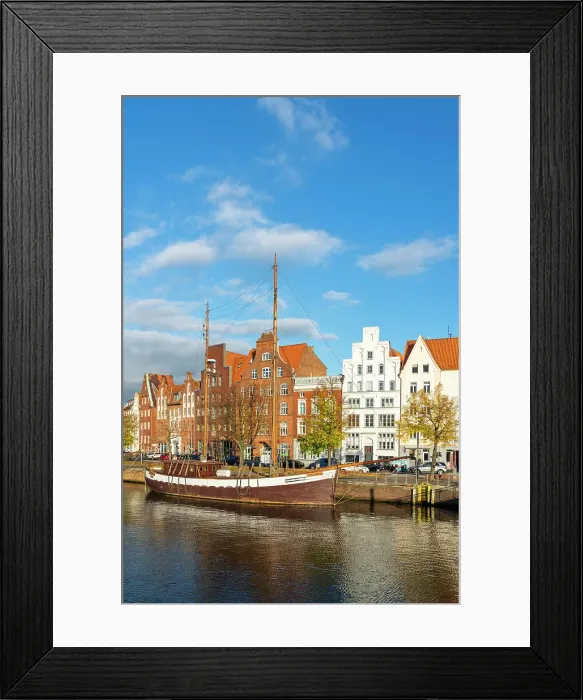 Framed Print : Boat anchored on Trave river and houses with traditional gables in background, Lubeck, UNESCO, Schleswig-Holstein, Germany