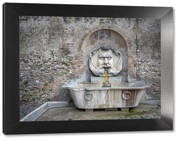 Europe, Italy, Rome. Characteristic fountain with the great mask near the Orange Garden on the Aventine hill