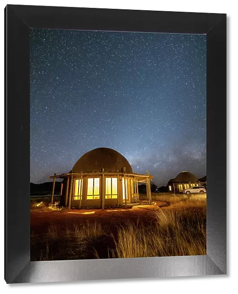 Namibia, illuminated rooms under the milky way in a game reserve safari lodge in Namib Naukluft National Park