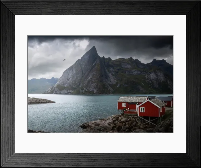 Framed Print : A gloomy afternoon at Hamnoy, with the classic red cabins and the rugged mountains in the background. Lofoten Islands, Norway Framed Print : A gloomy afternoon at Hamnoy, with the classic red cabins and the rugged mountains in the background. Lofoten Islands, Norway