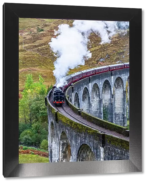 The Jacobite Steam Train, better otherwise known as the Harry Potter Train, crossing the viaduct of Glenfinnan, Glenfinnan, Highland, Scotland, UK
