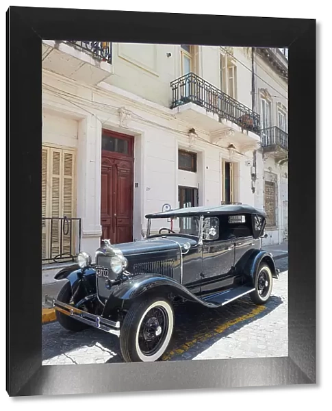 A vintage Ford Model A car in front of a colonial house in San Telmo, Buenos Aires, Argentina