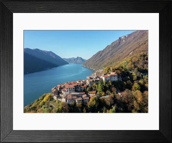 Framed Print : A look at the rough stone walls of the houses in the idyllic village of Castello, built on a cliff, dates back to the 16th century In the background San Mamete, and Mount San Salvatore, in Swiss territory Framed Print : A look at the rough stone walls of the houses in the idyllic village of Castello, built on a cliff, dates back to the 16th century In the background San Mamete, and Mount San Salvatore, in Swiss territory