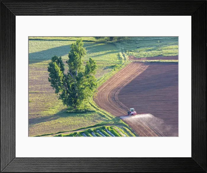 Framed Print : France, Nouvelle-Aquitaine, Dordogne, Perigord, Domme, a tractor sprays a field near Domme Framed Print : France, Nouvelle-Aquitaine, Dordogne, Perigord, Domme, a tractor sprays a field near Domme