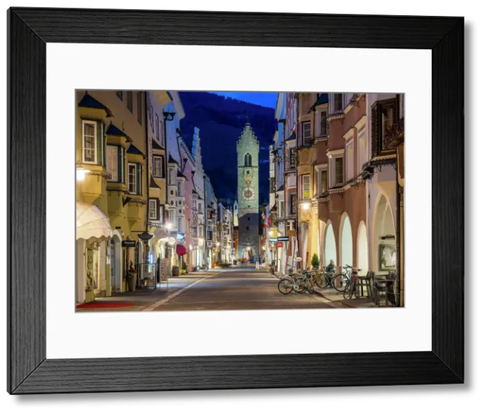 Framed Print : Night view of the main street with Zwolferturm medieval tower in the background, Sterzing-Vipiteno, Trentino-Alto Adige / Sudtirol, Italy Framed Print : Night view of the main street with Zwolferturm medieval tower in the background, Sterzing-Vipiteno, Trentino-Alto Adige / Sudtirol, Italy