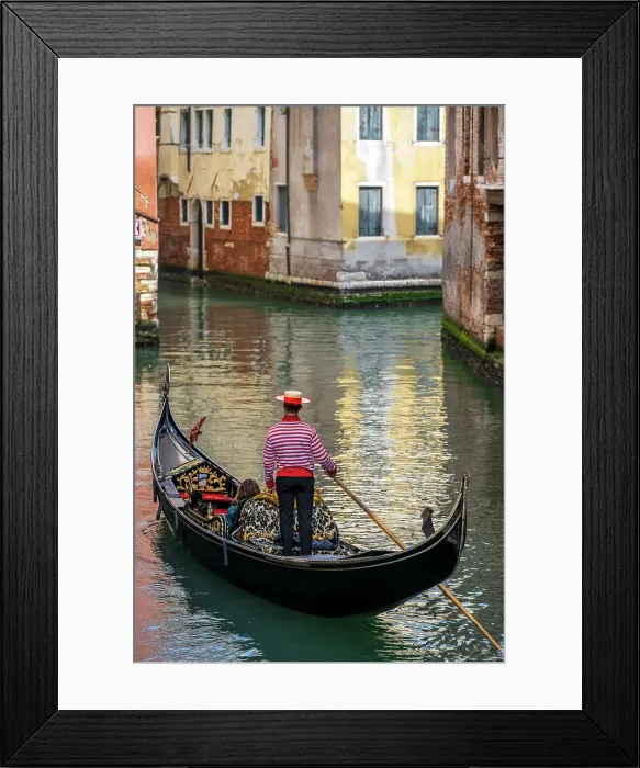 Framed Print : Gondolier with hat on gondola boat in a water canal, Venice, Veneto, Italy Framed Print : Gondolier with hat on gondola boat in a water canal, Venice, Veneto, Italy