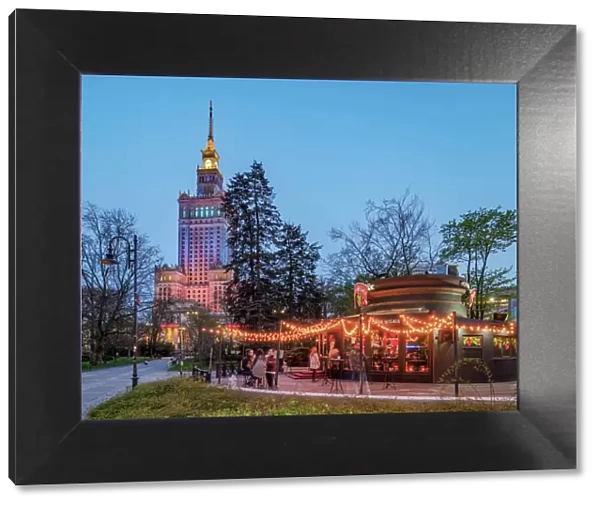 Palace of Culture and Science and Pijana Wisnia Wine Bar at dusk, Warsaw, Masovian Voivodeship, Poland