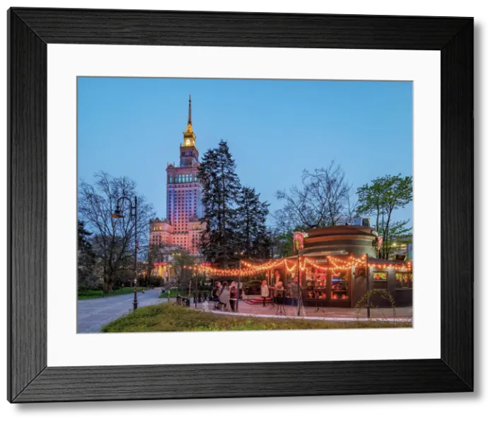 Framed Print : Palace of Culture and Science and Pijana Wisnia Wine Bar at dusk, Warsaw, Masovian Voivodeship, Poland