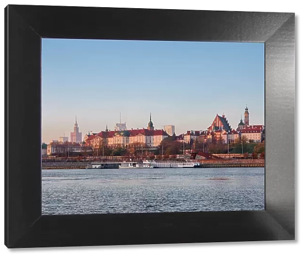 View over River Vistula towards The Old Town and Royal Castle at sunrise, Warsaw, Masovian Voivodeship, Poland