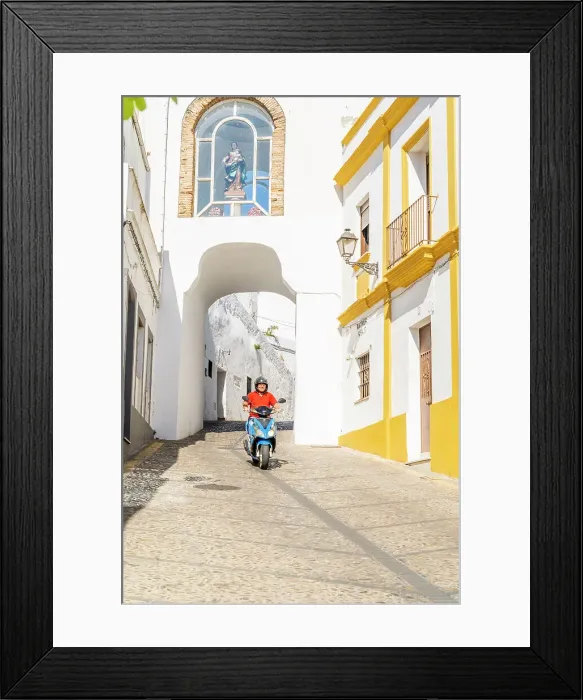 Framed Print : Man riding a scooter through Puerta de Matrera, Arcos de la Frontera, Andalusia, Spain Framed Print : Man riding a scooter through Puerta de Matrera, Arcos de la Frontera, Andalusia, Spain