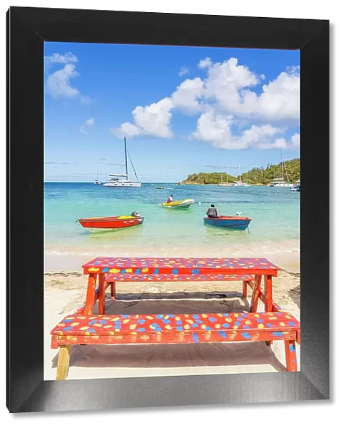 A colourful bench on Salt Whistle bay Beach, Mayreau Island in the Tobago Cays in the Grenadines Islands, Saint Vincent and the Grenadines, Caribbean