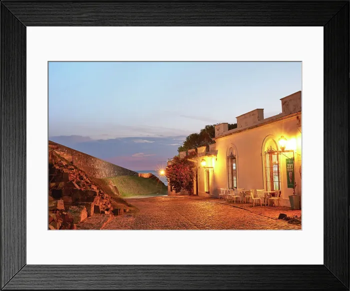Framed Print : A cobbled street and the Bastion of San Miguel fortified wall at twilight, with the Rio de la Plata river in the background, Colonia del Sacramento, Uruguay Framed Print : A cobbled street and the Bastion of San Miguel fortified wall at twilight, with the Rio de la Plata river in the background, Colonia del Sacramento, Uruguay