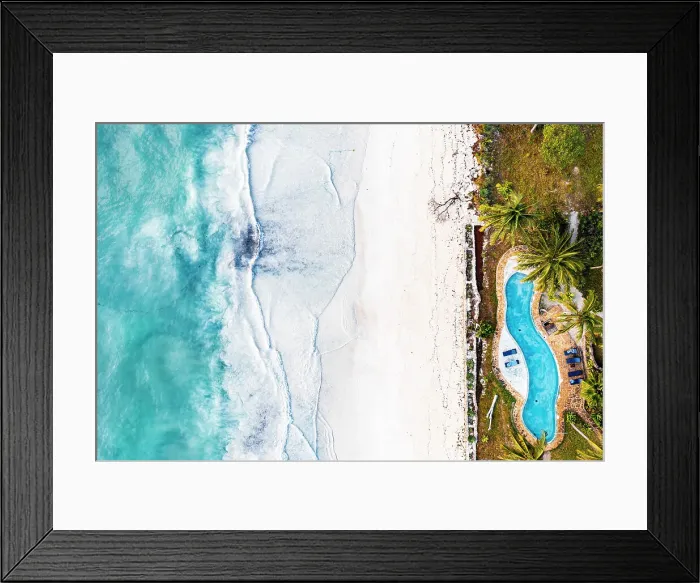 Framed Print : Swimming pool of a tourist resort on white coral beach washed by waves, overhead view, Zanzibar, Tanzania Framed Print : Swimming pool of a tourist resort on white coral beach washed by waves, overhead view, Zanzibar, Tanzania