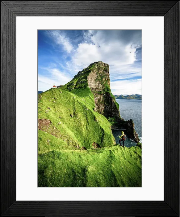 Framed Print : Hiker admiring Kallur lighthouse and Borgarin mountain peak standing on top of cliffs, Kalsoy island, Faroe Islands, Denmark Framed Print : Hiker admiring Kallur lighthouse and Borgarin mountain peak standing on top of cliffs, Kalsoy island, Faroe Islands, Denmark