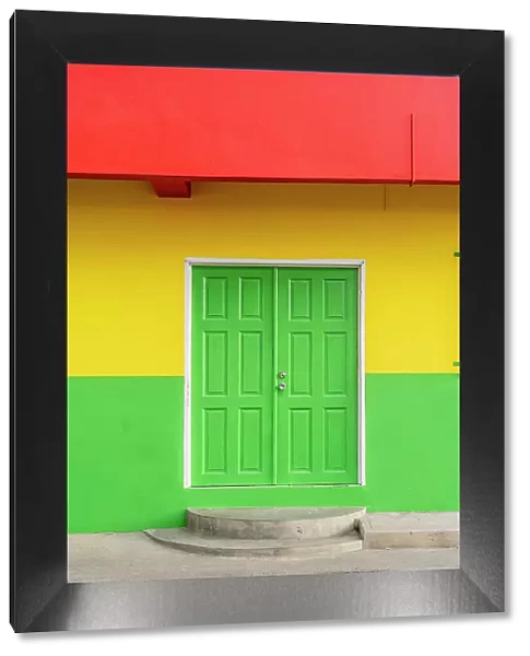 Colourful local building in the Grenedian flag colours, Hillsborough, Carriacou Island, Grenada, Caribbean