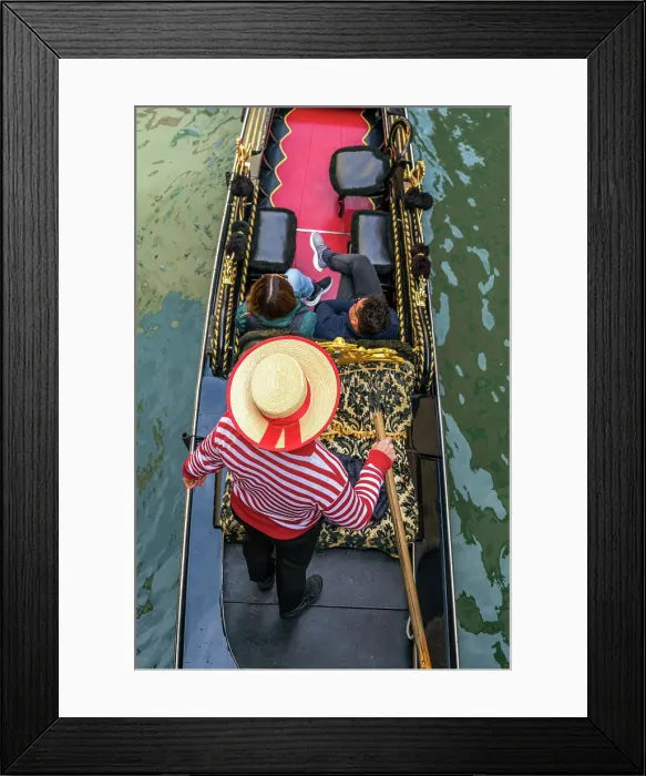 Framed Print : Gondolier with hat on gondola boat in a water canal, Venice, Veneto, Italy Framed Print : Gondolier with hat on gondola boat in a water canal, Venice, Veneto, Italy