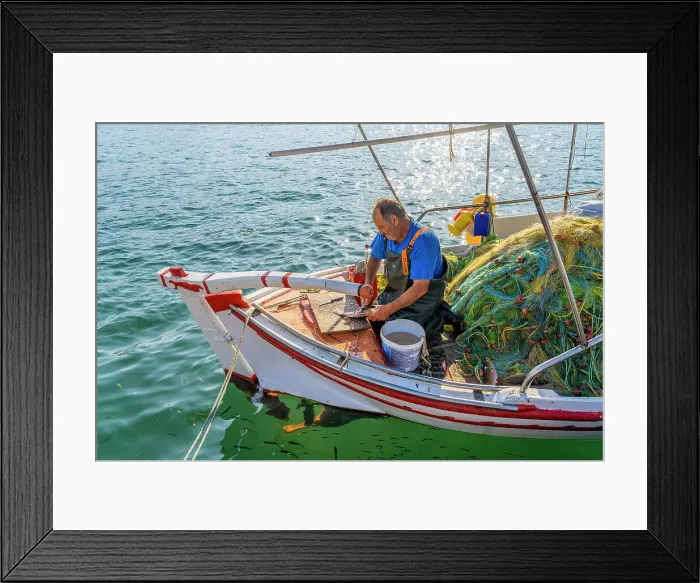 Framed Print : Fisherman cleaning fish in Argostoli, Kefalonia, Ionian Islands, Greek Islands, Greece