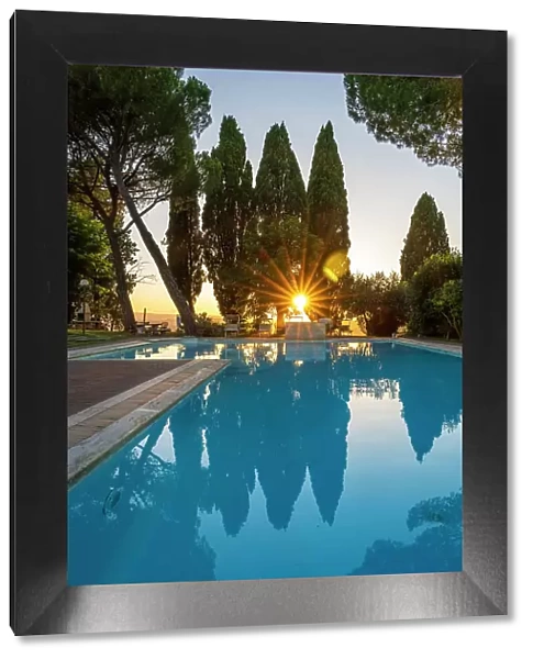 Italy, Tuscany. Sunset at the pool of the Agriturismo Pieve Sprenna near to Buonconvento