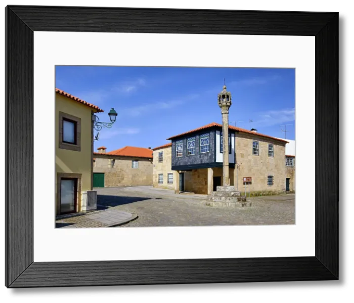 Framed Print : Historic center of Sernancelhe. The 16th century pillori and a beautiful medieval house. Sernancelhe, Beira Alta. Portugal Framed Print : Historic center of Sernancelhe. The 16th century pillori and a beautiful medieval house. Sernancelhe, Beira Alta. Portugal