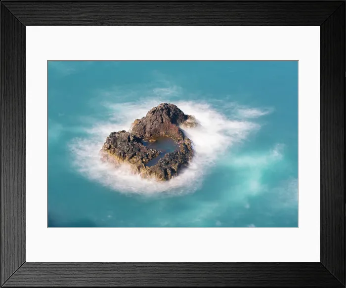 Framed Print : Aerial view of small rock island amongst waves, Madeira, Portugal Framed Print : Aerial view of small rock island amongst waves, Madeira, Portugal