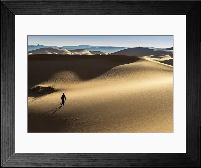 Framed Print : Man walking on the Erg Chebbi dunes in the Sahara Desert, Merzouga, Morocco