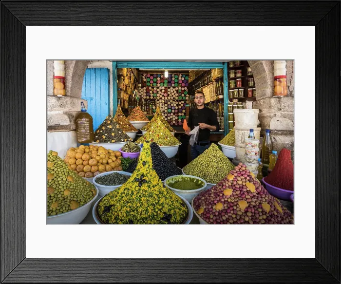 Framed Print : Vendor in olive and spice shop in market in the medina (old city), Essaouira, Morocco Framed Print : Vendor in olive and spice shop in market in the medina (old city), Essaouira, Morocco