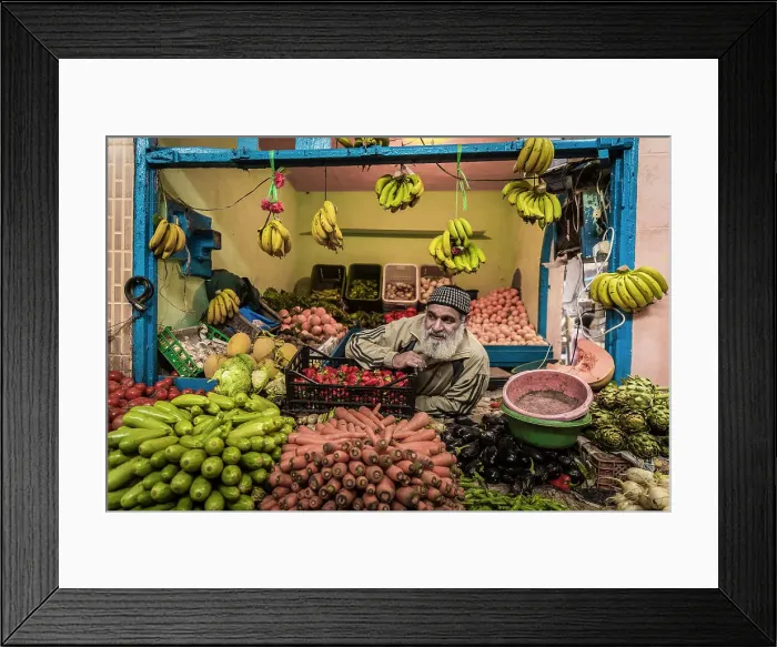 Framed Print : Vendor at fruit and vegetable stall in market in the medina (old city), Essaouira, Morocco Framed Print : Vendor at fruit and vegetable stall in market in the medina (old city), Essaouira, Morocco