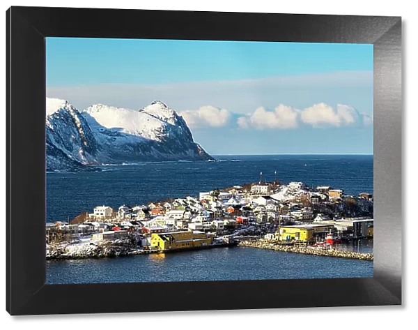 Panoramic of Husoy island and small harbor in between sea and snowy mountains, Senja, Troms county, Norway