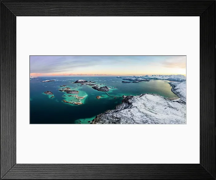 Framed Print : Panoramic aerial view of Sommaroy island in between snowy mountains and frozen sea at dawn, Troms county, Norway Framed Print : Panoramic aerial view of Sommaroy island in between snowy mountains and frozen sea at dawn, Troms county, Norway