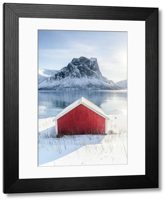 Framed Print : Snowy rorbu overlooking the frozen sea, Bergsfjorden, Senja, Troms county, Norway