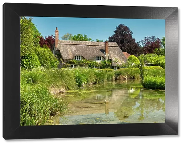 Thatched Cottage Reflecting in Village Pond, Sherrington, Wiltshire, England