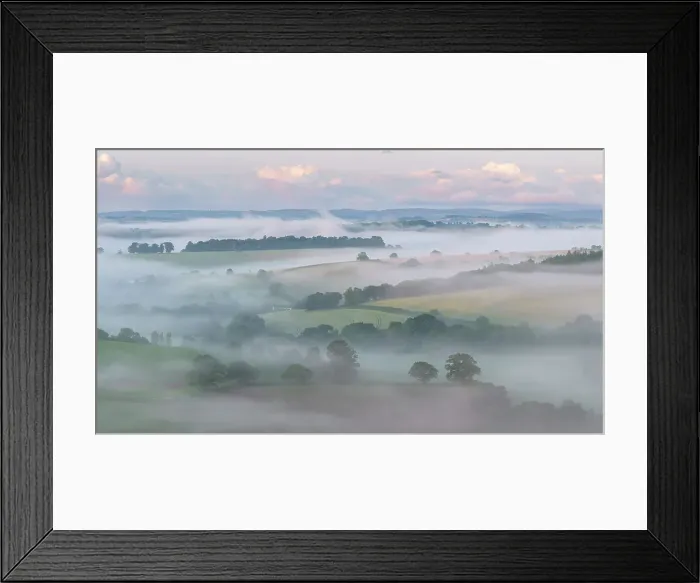 Framed Print : Aerial view of mist shrouded countryside at dawn, Crediton, Devon, England. Summer (June) 2023